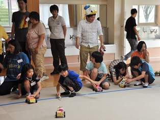 ゴム動力ミニカーで遊ぶ子どもたち